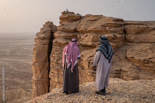 2 men in traditional clothing at the Edge of the World near Riyadh in Saudi Arabia photo