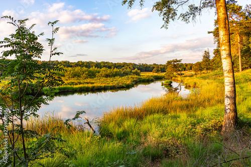 View from a hill during a late sunny afternoon on the Lake ' Patersmoer' near Strijbeek, Netherlands photo