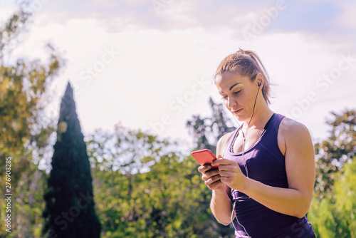 woman checking her phone app before running