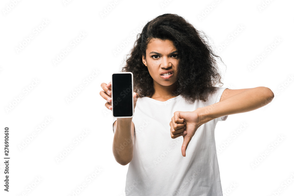 displeased african american girl holding smartphone with blank screen and showing thumb down isolated on white displeased african american girl holding smartphone with blank screen and showing thumb down isolated on white