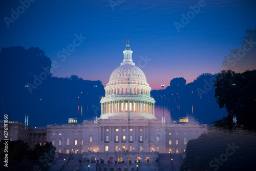 Multiple exposure view of the US Capitol Building aligned with the Washington Monument under colorful sunset DC sky