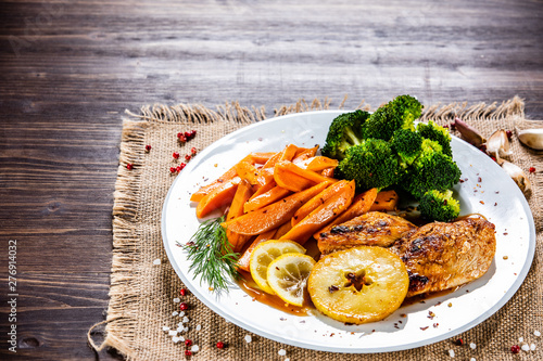 Grilled chicken breast, French fries and vegetable salad