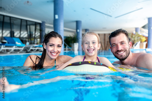 Happy parents with their daughter having fun in the swimming pool © didesign