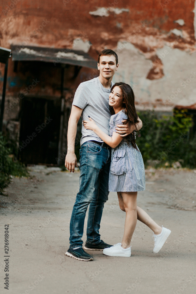 Happy young couple in love teenagers friends dressed in casual style  walking together on old city street Stock Photo | Adobe Stock