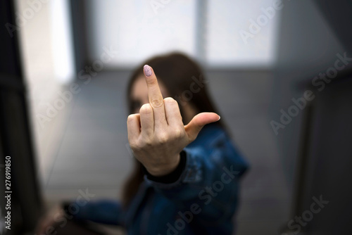 Young caucasian girl showing middle finger fuck you