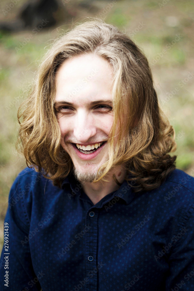 Portrait of a young man with long hair and beard