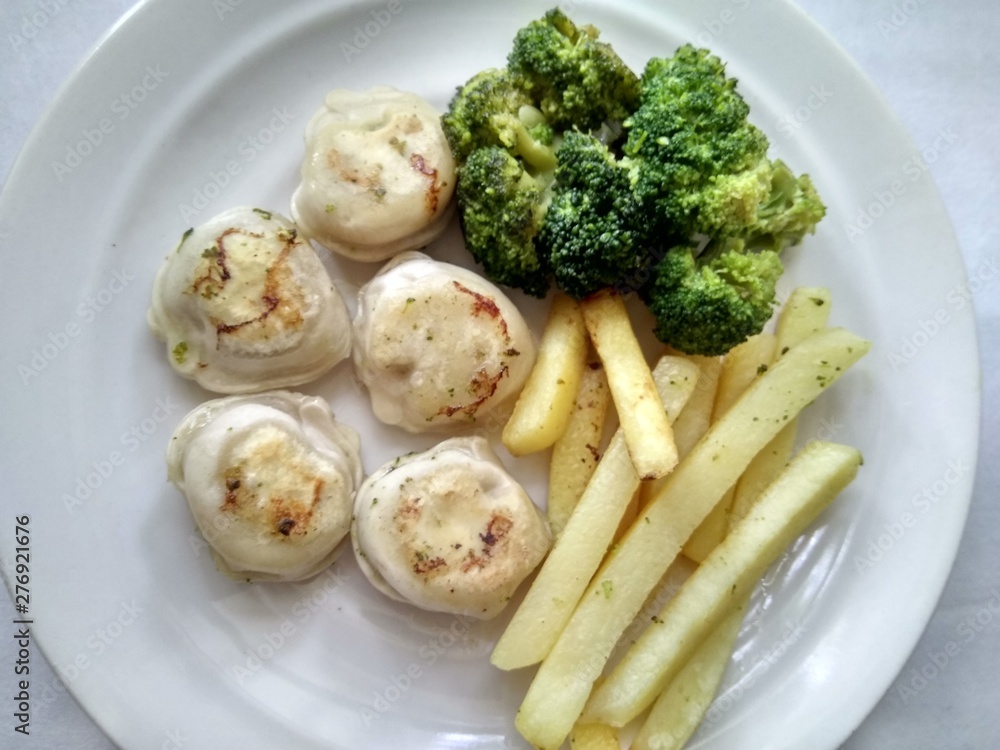 food photo, broccoli dinner with potatoes on a white plate