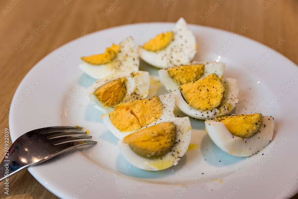 Boiled eggs with salt pepper and olive oil