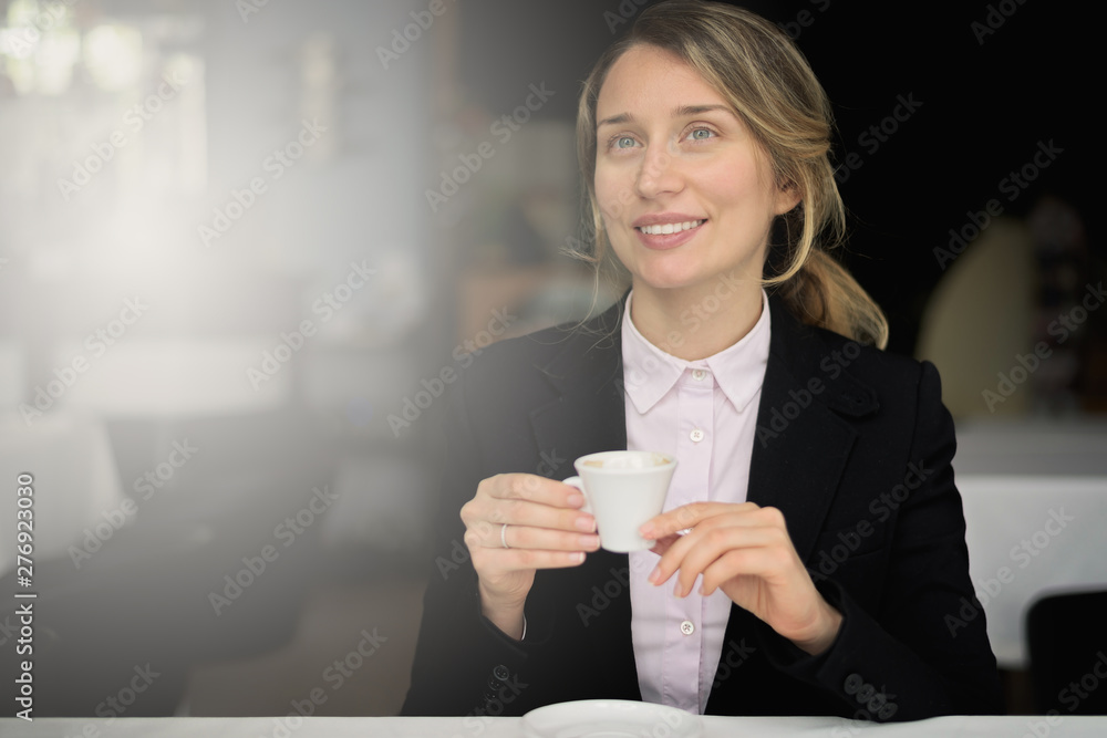 Happy young blonde woman drinking coffee Happy young blonde woman drinking coffee