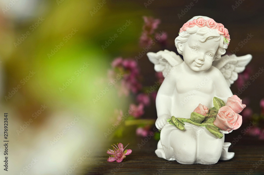 Guardian angel holding bunch of roses