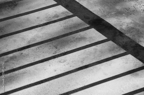 shadow of the cage on a cement floor