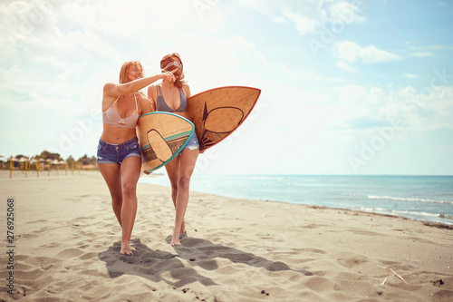 water sports. Healthy Active Lifestyle. Surfing. Summer Vacation. Surfer women’s in bikini go to surfing...