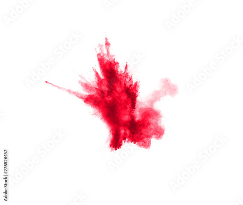 Abstract red dust splattered on white background. Red powder explosion.Freeze motion of red particles splash.