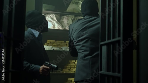 Two ardmed men robbing a bank