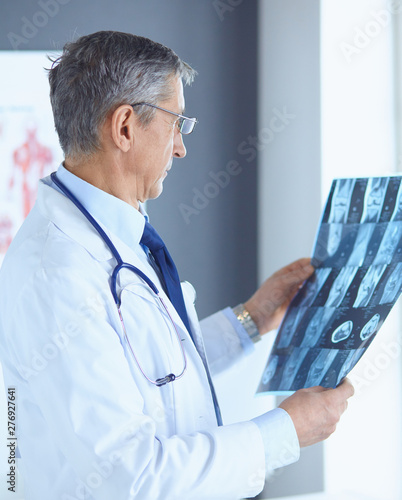 Doctor in the office examines the patient's x-ray