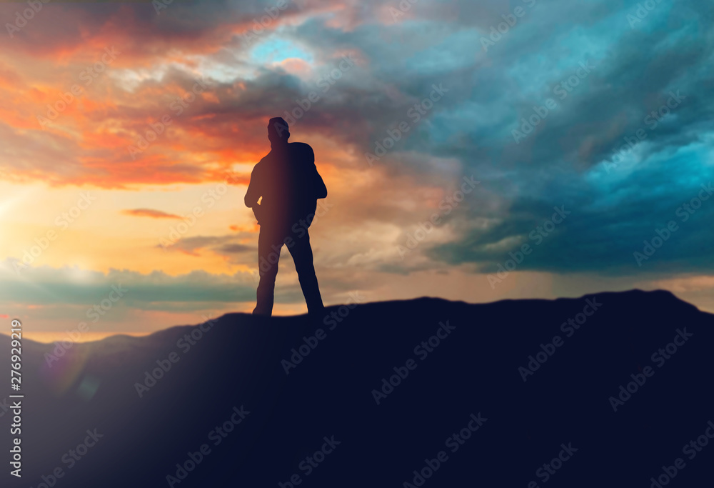 travel, tourism, hike and people concept - traveller with backpack standing on edge of hill over sunset background