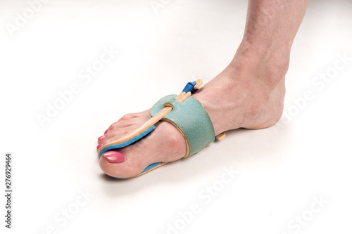  stabilizing orthosis for the correction of the big toe on the woman leg when hallux valgus, 1 foot, close-up isolated, white background photo