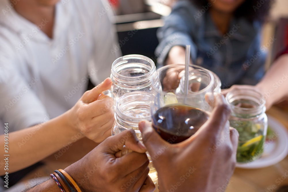 leisure, food and people concept - group of happy international friends clinking glasses at bar or restaurant leisure, food and people concept - group of happy international friends clinking glasses at bar or restaurant