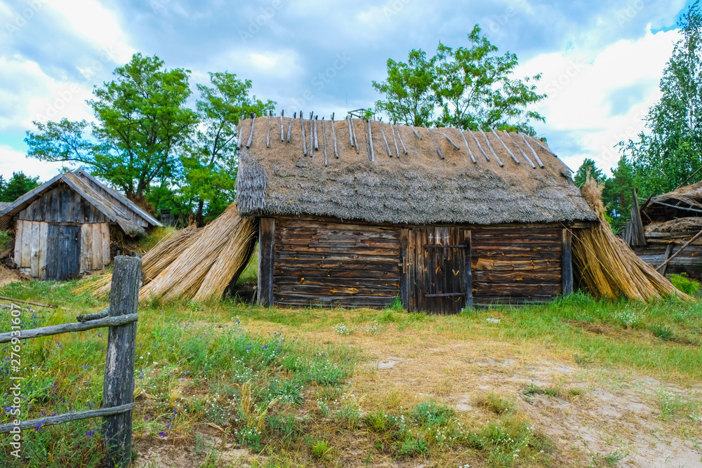 Folk abandoned oldest habitation under a reed roof in the disappearing village of Svalovichi in the Ukraine. Ukrainian Polissya. Folk abandoned oldest habitation under a reed roof in the disappearing village of Svalovichi in the Ukraine. Ukrainian Polissya.