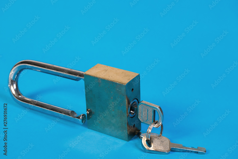 Padlock and keys isolated on blue background