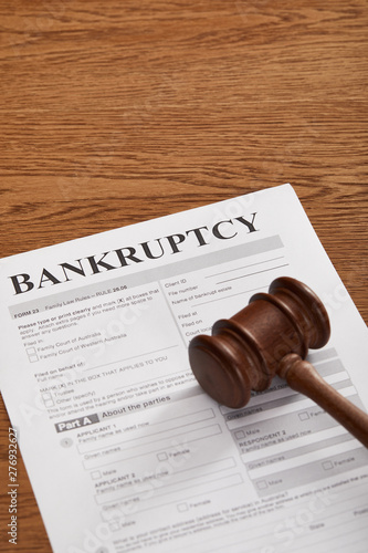 bankruptcy form under wooden gavel on brown wooden table photo