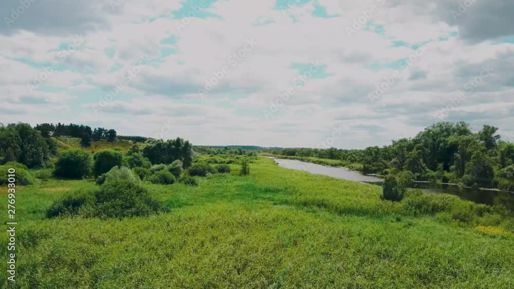 the river goes into the distance surrounded by green trees on a clear day the river goes into the distance surrounded by green trees on a clear day