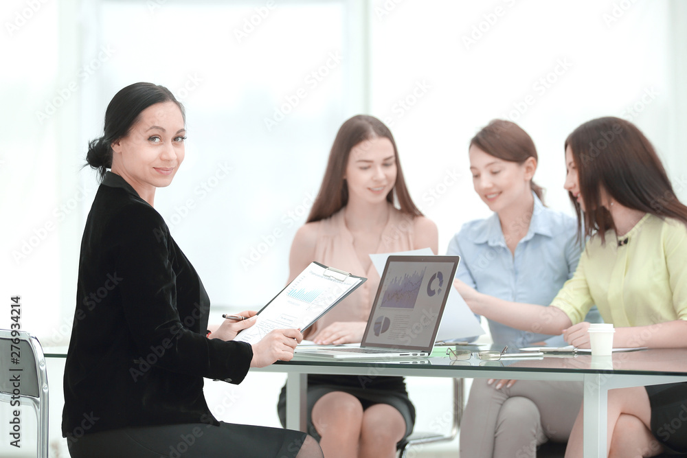 adult business woman and group of young employees at work Desk adult business woman and group of young employees at work Desk