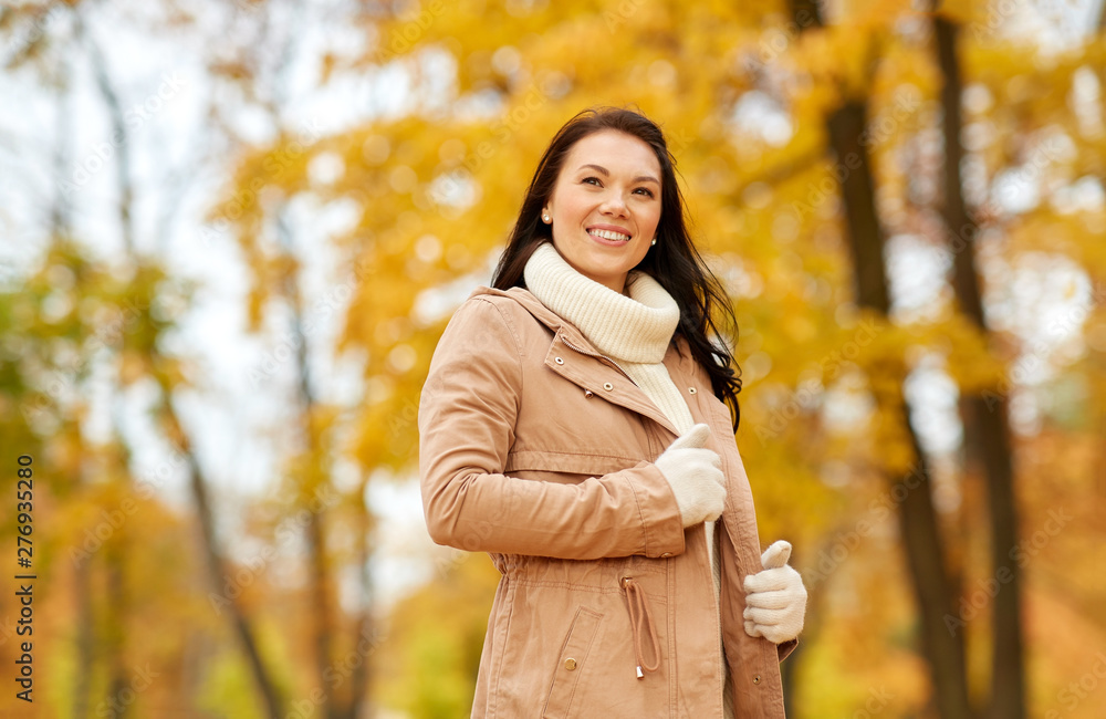 season, fashion and people concept - happy young woman smiling in autumn park season, fashion and people concept - happy young woman smiling in autumn park