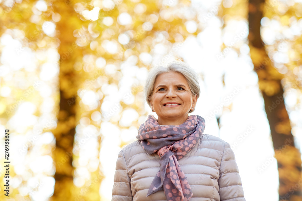 old age, retirement and season concept - portrait of happy senior woman at autumn park old age, retirement and season concept - portrait of happy senior woman at autumn park