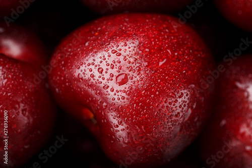 Ripe and fresh berries of a sweet cherry with water drops closeup.