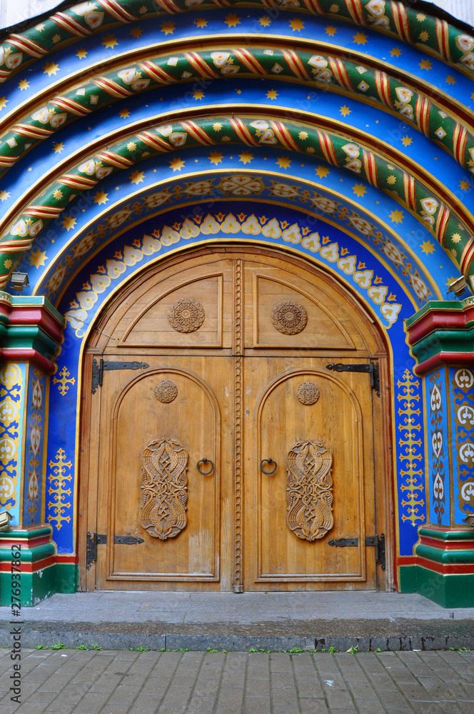 Old Russian heavy wooden doors of brown color. Arch.