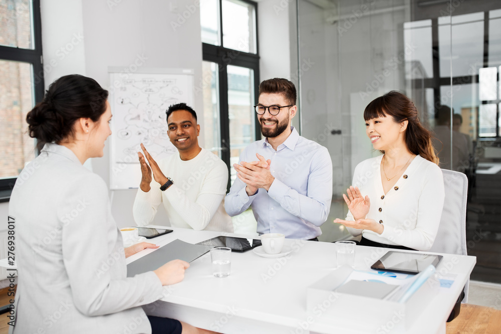 new job, hiring and employment concept - international team of recruiters having interview with female employee at office new job, hiring and employment concept - international team of recruiters having interview with female employee at office