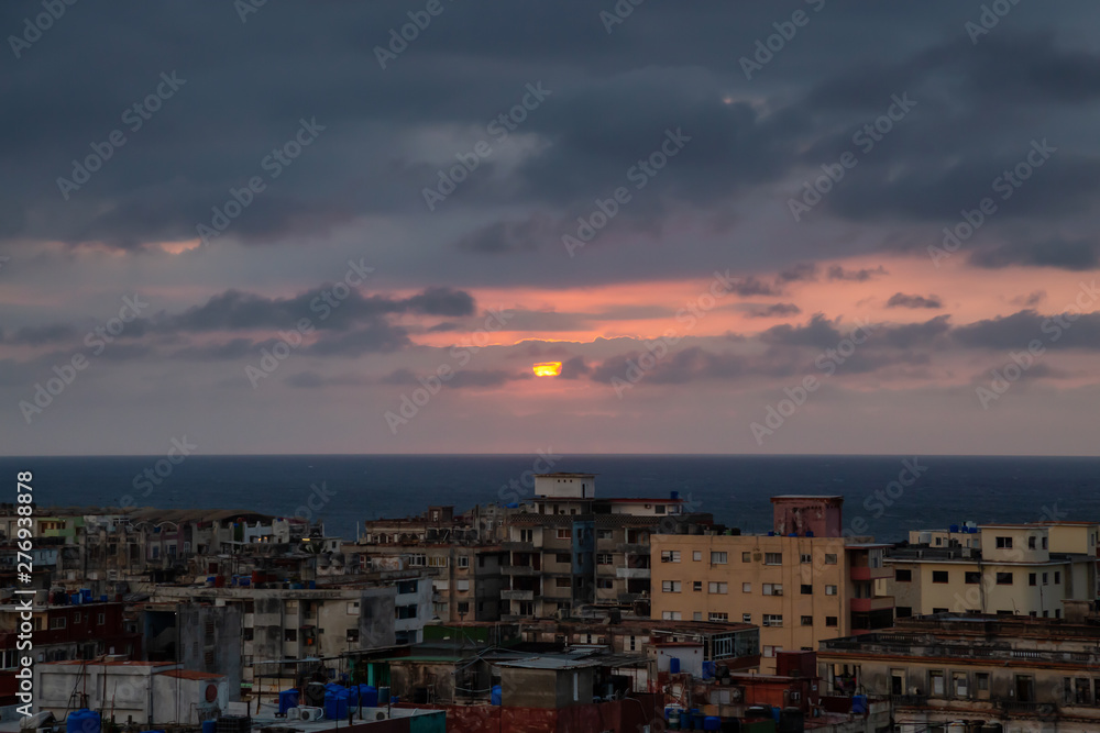 Aerial view of the residential neighborhood in the Havana City, Capital of Cuba, during a colorful and cloudy sunset. Aerial view of the residential neighborhood in the Havana City, Capital of Cuba, during a colorful and cloudy sunset.