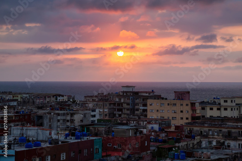 Aerial view of the residential neighborhood in the Havana City, Capital of Cuba, during a colorful and cloudy sunset. © edb3_16