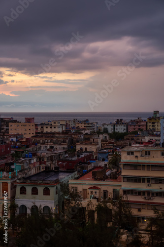 Aerial view of the residential neighborhood in the Havana City  Capital of Cuba  during a colorful  and rainy sunset.