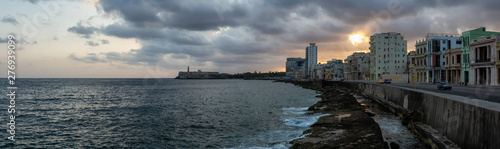 Photography Beautiful panoramic view of the Old Havana City, Capital of Cuba, by the Ocean Coast during a dramatic and cloudy sunrise