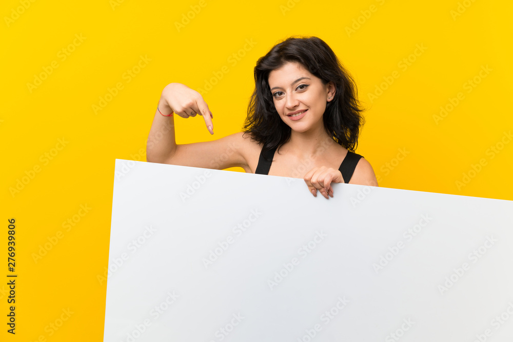Young woman over isolated yellow background holding an empty white placard for insert a concept Young woman over isolated yellow background holding an empty white placard for insert a concept