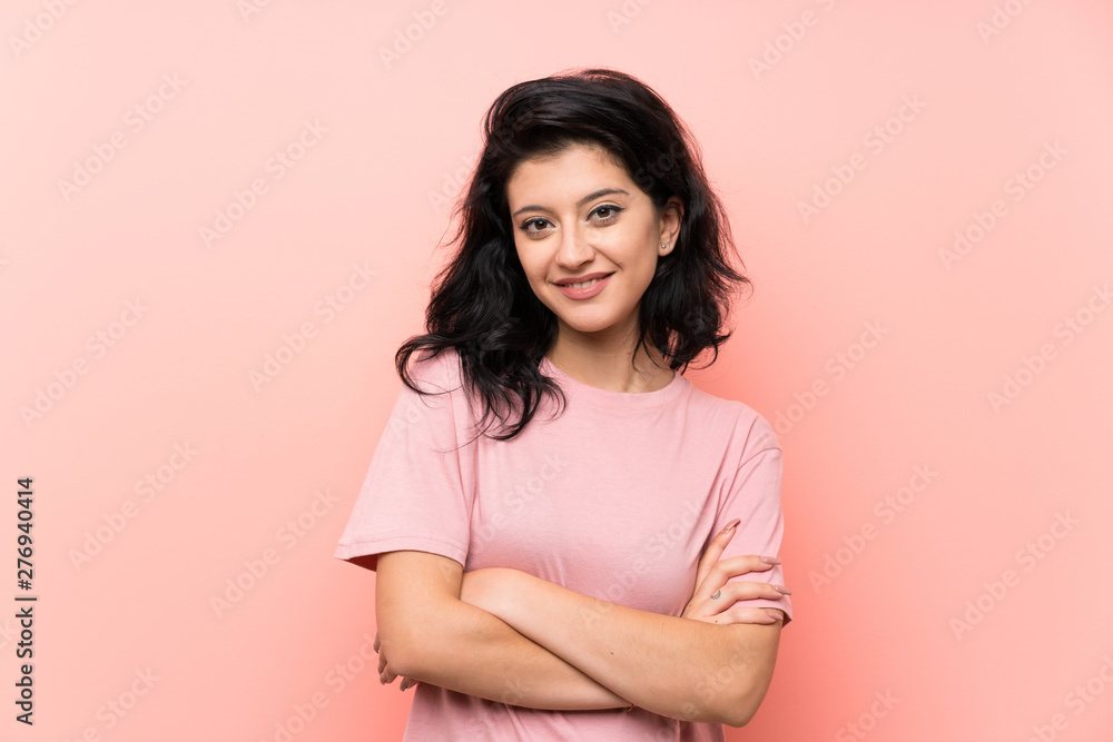Fototapeta premium Young woman over isolated pink background laughing