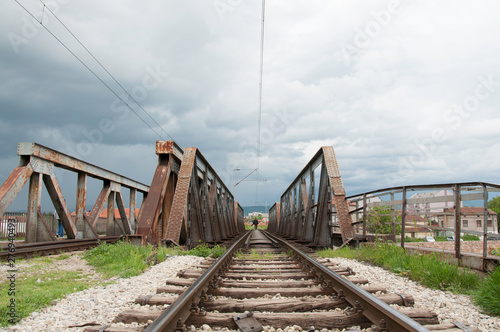 Man walking on a rail bridge