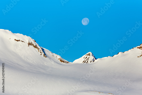 the moon in the snowy mountains