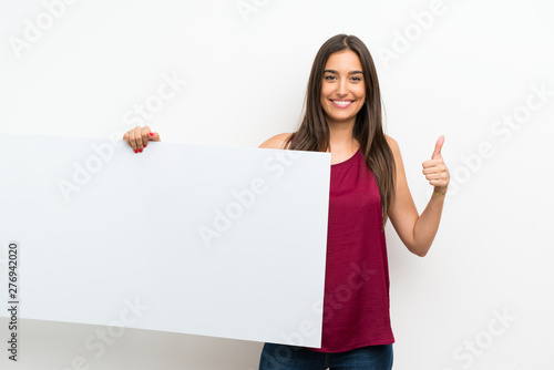 Young woman over isolated white background holding an empty white placard for insert a concept