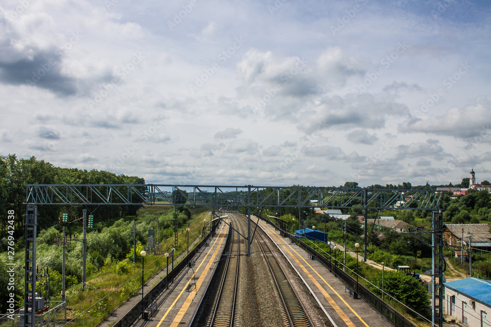 Top view of the railway and the surrounding summer landscape