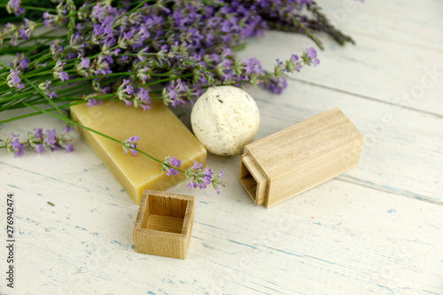 The concept of home comfort with lavender soap. Lavender flowers on shaby white wooden background with bokeh and soap. photo