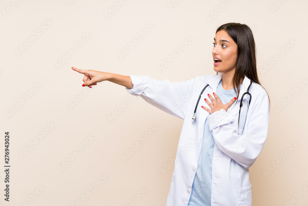 Young doctor woman over isolated background pointing finger to the side Young doctor woman over isolated background pointing finger to the side