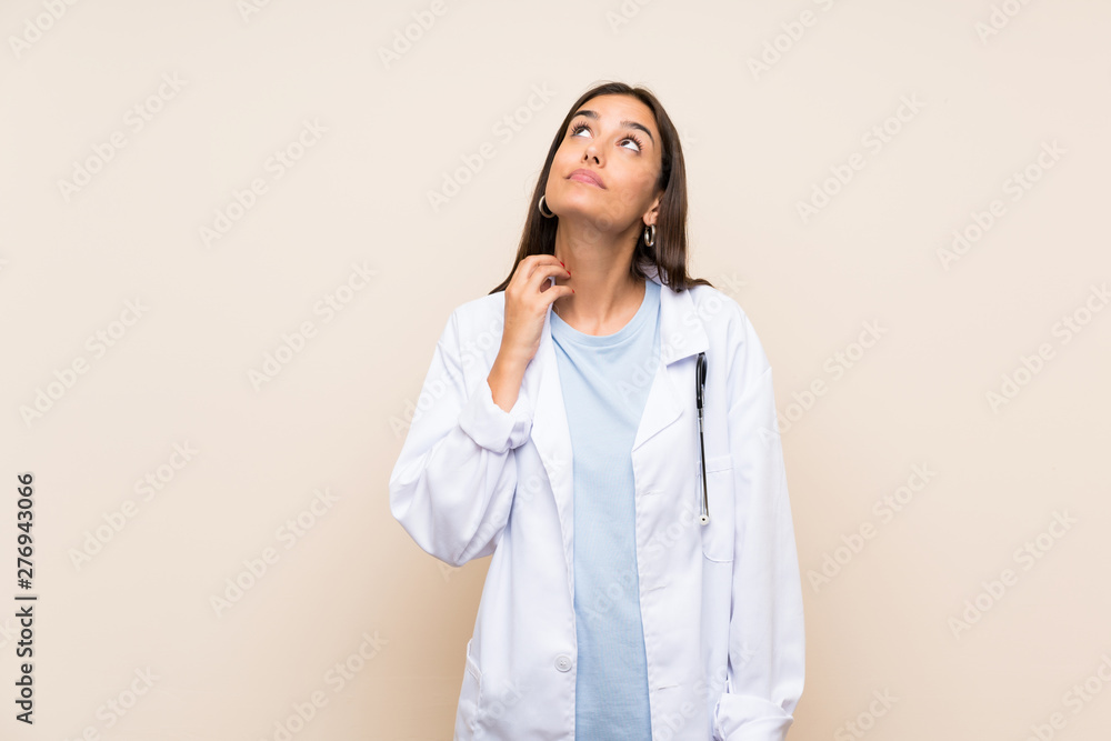 Young doctor woman over isolated background thinking an idea Young doctor woman over isolated background thinking an idea