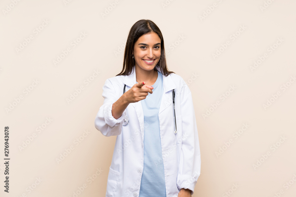 Young doctor woman over isolated background points finger at you Young doctor woman over isolated background points finger at you