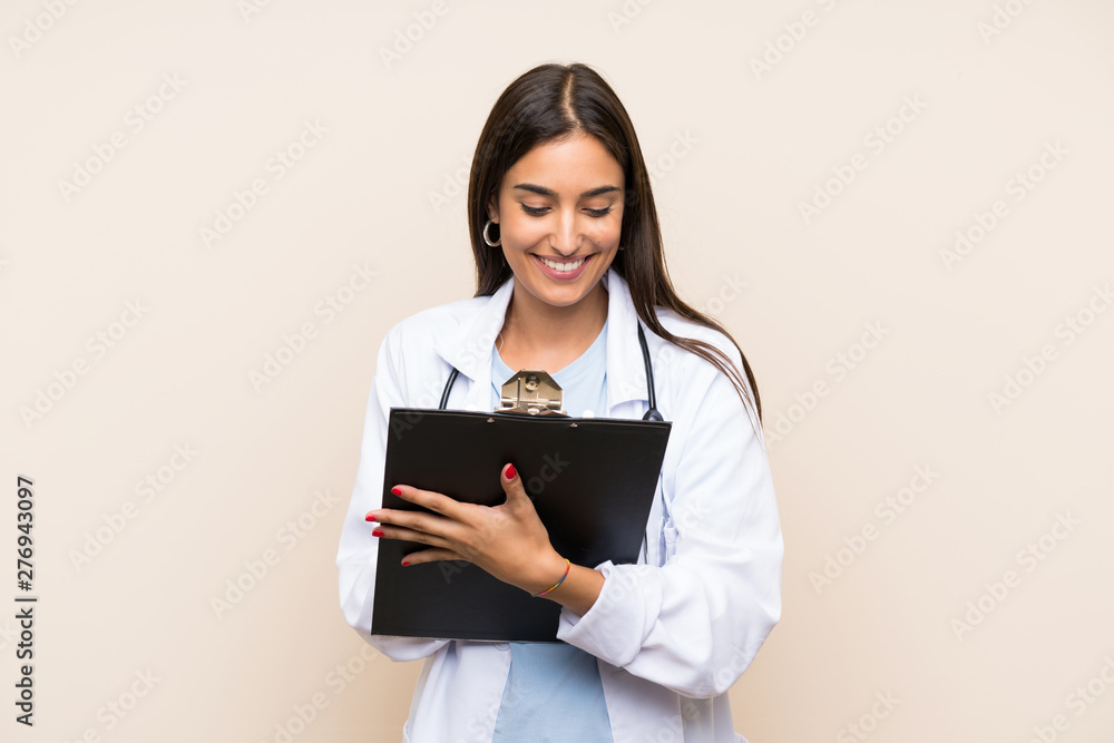 Young doctor woman over isolated background holding a folder Young doctor woman over isolated background holding a folder