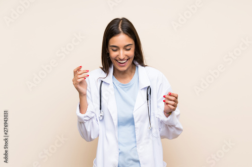Young doctor woman over isolated background laughing