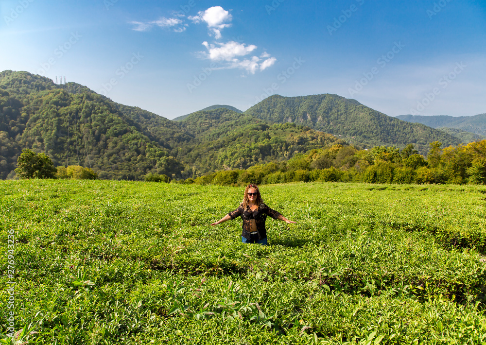 Smiling woman on a mountain tea plantation in Sochi, Russia Smiling woman on a mountain tea plantation in Sochi, Russia