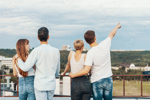 Group of friends enjoying outdoors at roof